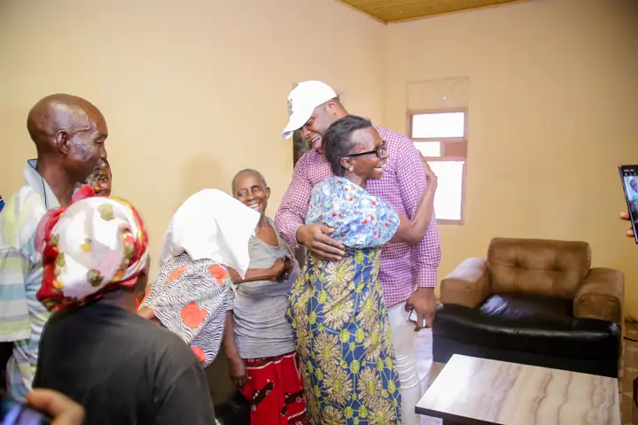 Embracing an elderly woman during a visit