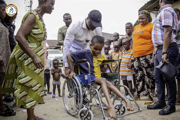 Helping a child in a wheelchair during an outreach