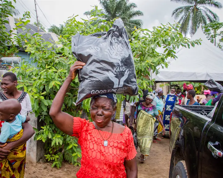 A woman carrying relief items on her head