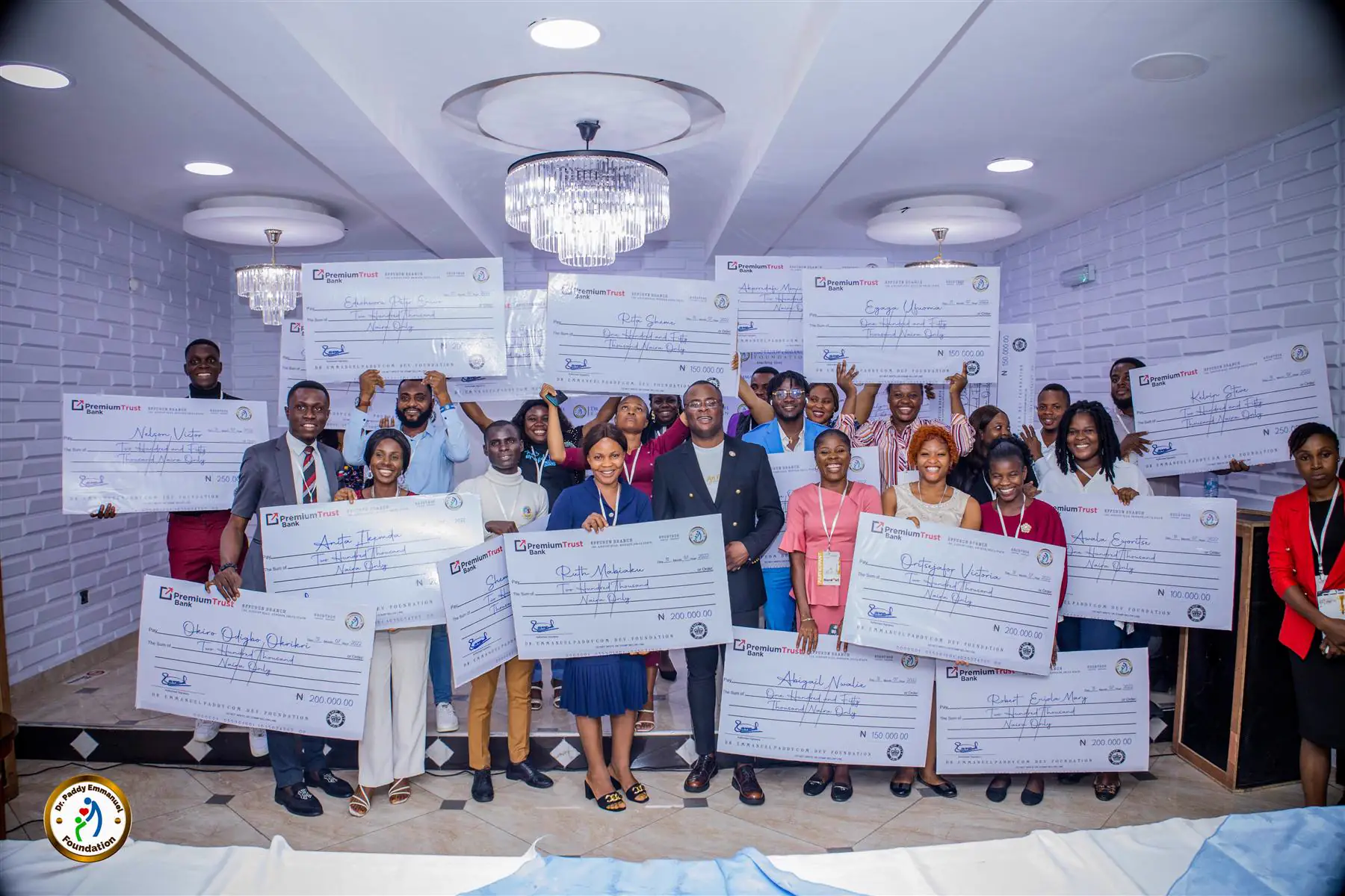 Young entrepreneurs holding grant cheques at the Advance programme