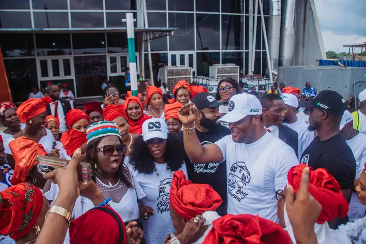 Dr Paddy Iyamu with a raised fist among supporters