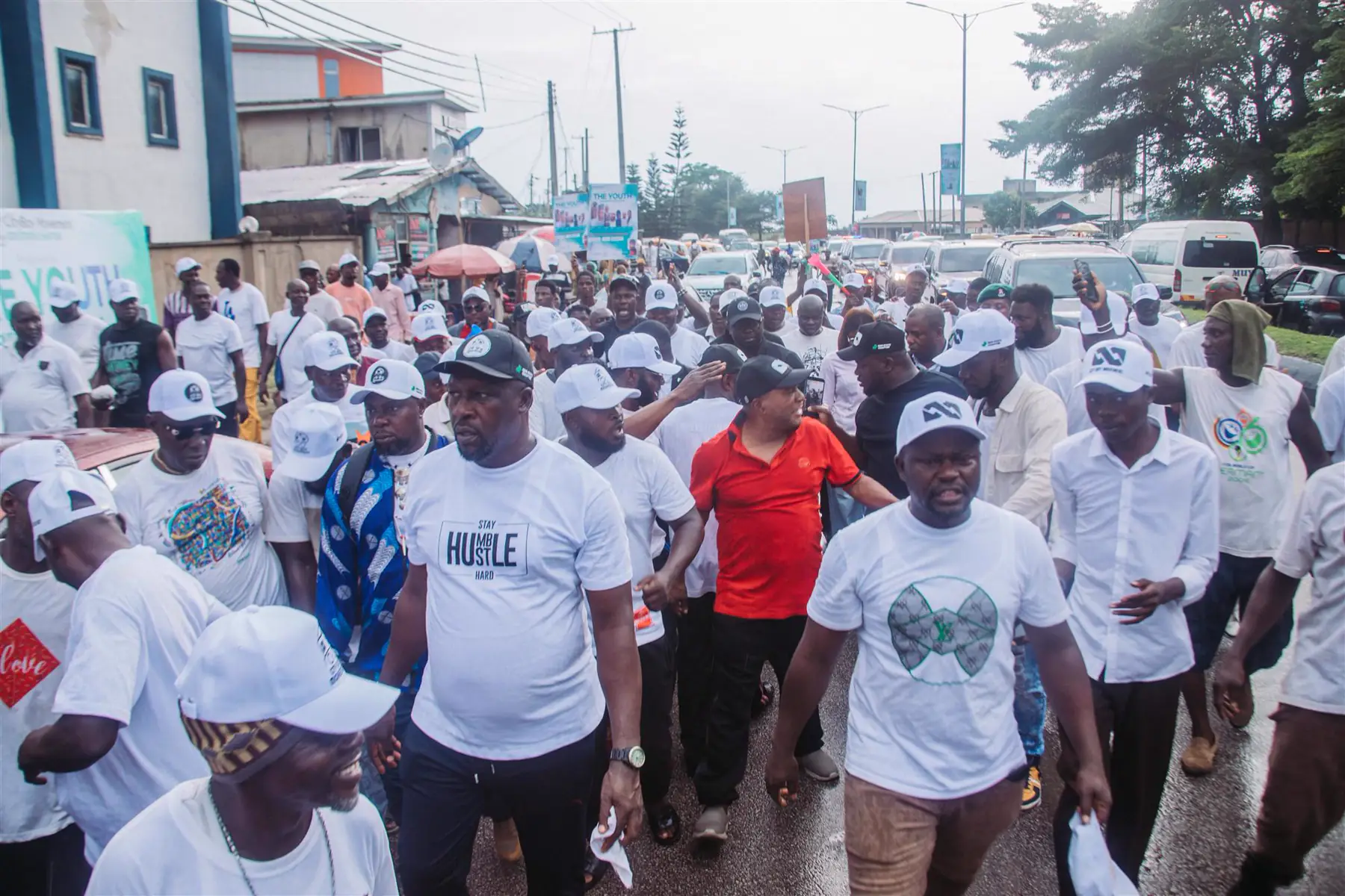 Dr Paddy Iyamu walking through a crowd of supporters