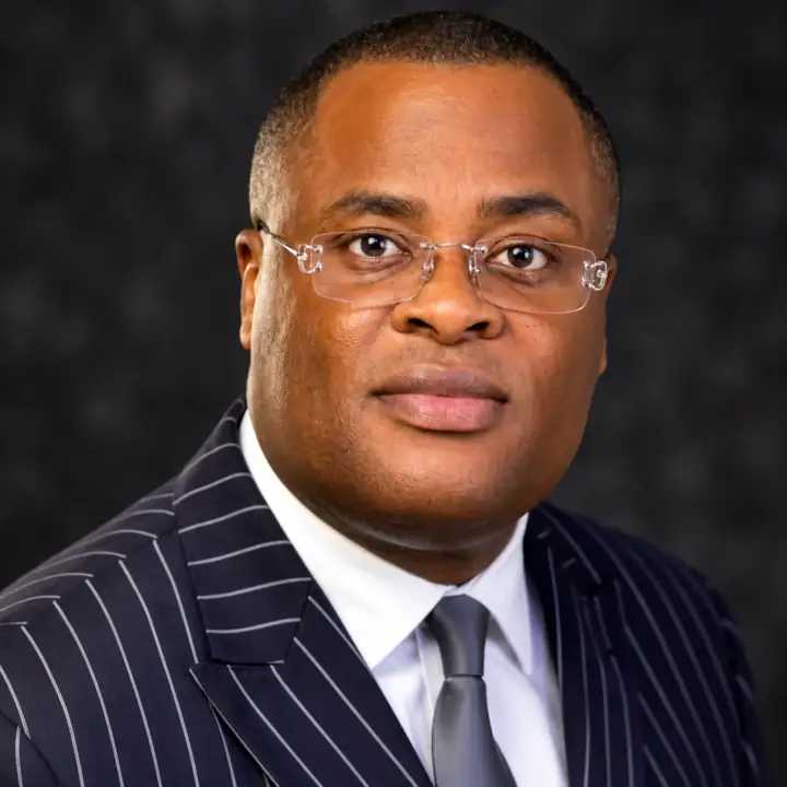 Portrait of Dr Paddy Iyamu in a navy pinstripe suit
