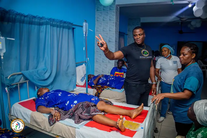 Checking on patients in a crowded outreach ward